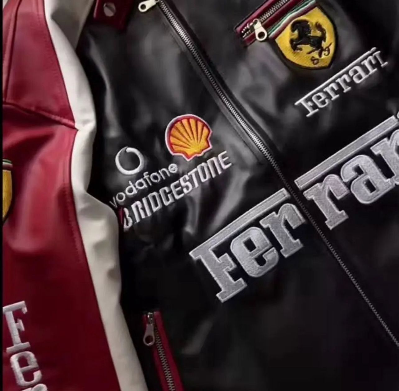 Close-up of Ferrari crest embroidered on maroon racing leather jacket
