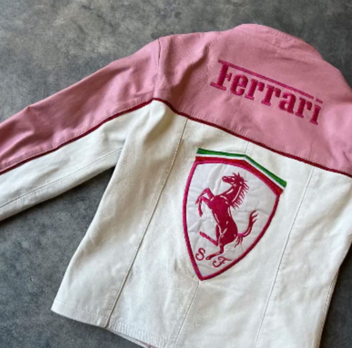 Back view of pink Ferrari jacket featuring motorsport sponsor patches