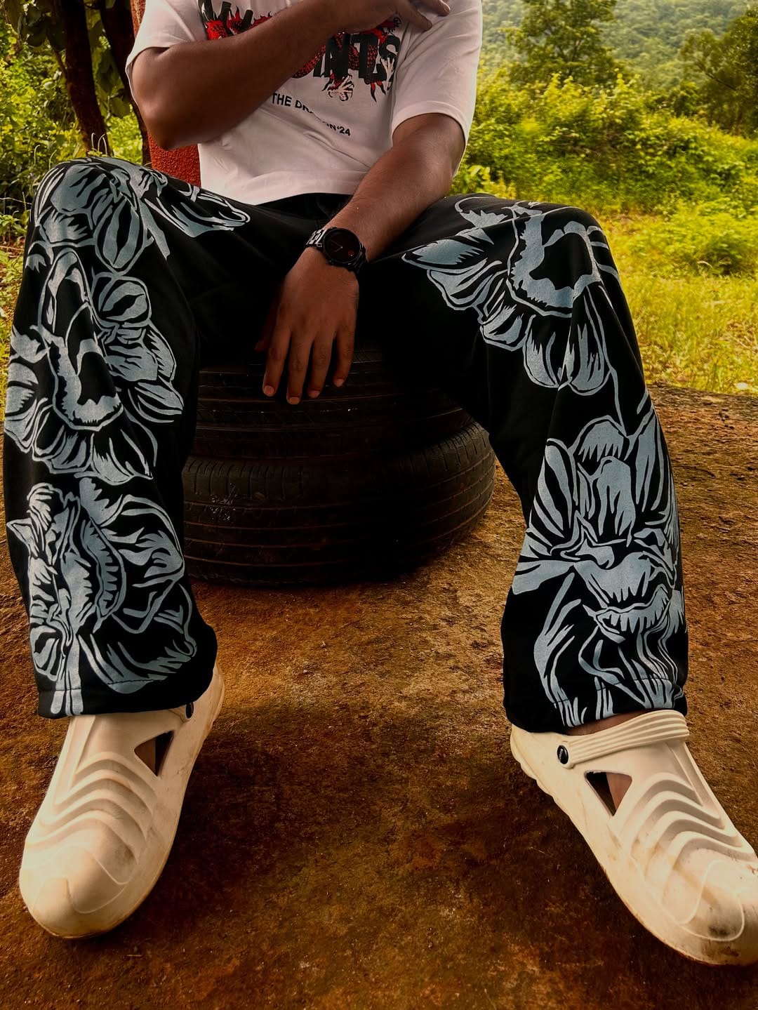 Sitting shot showing floral print drape on straight-fit pant