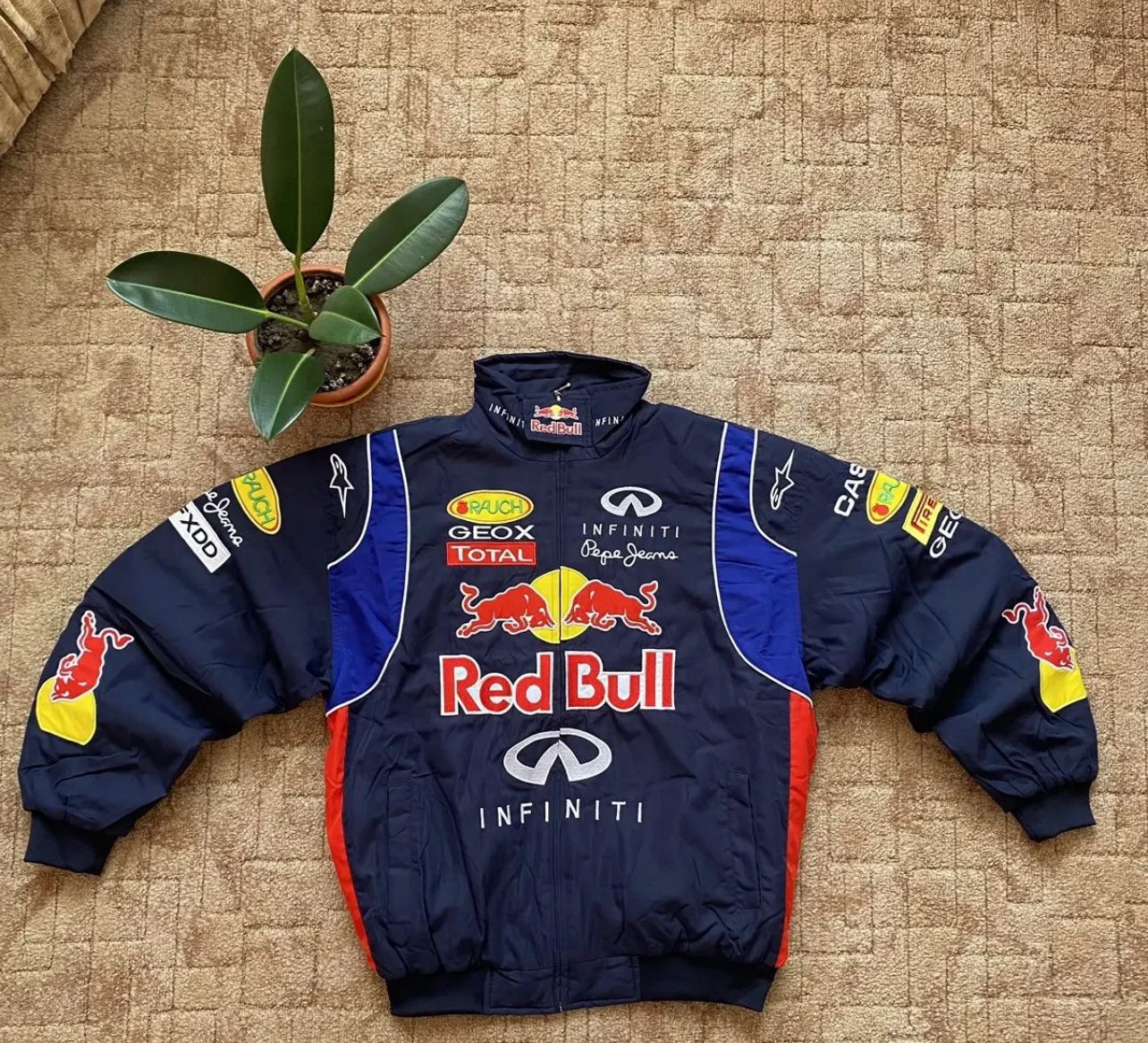 Flat lay of Red Bull Racing Jacket with bold logo embroidery on faux leather