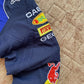 Close-up of embroidered Red Bull sponsor patch on F1 racing jacket