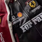 Close-up of Ferrari crest embroidered on maroon racing leather jacket