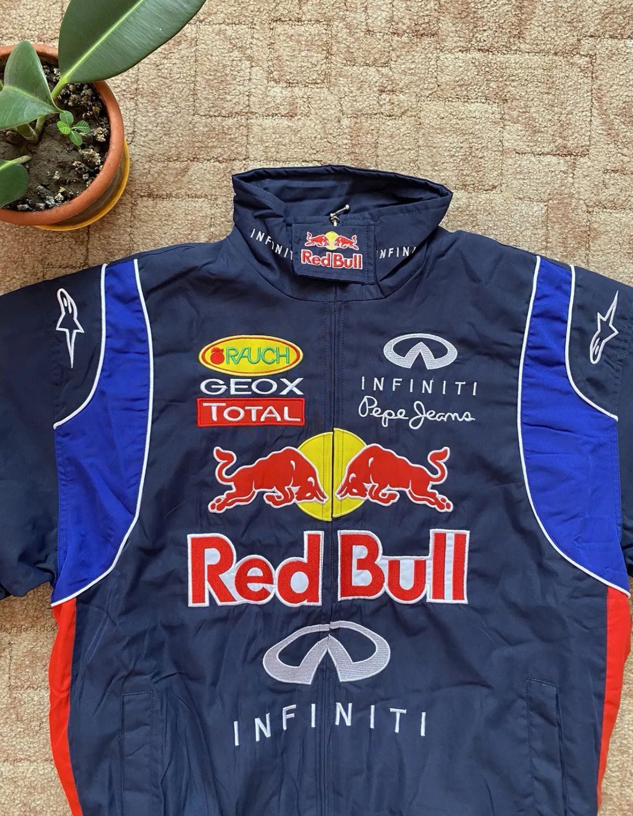 Flat lay of Red Bull Racing Jacket with bold logo embroidery on faux leather