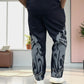 Back view of straight-fit pant in solid black with puff print accents