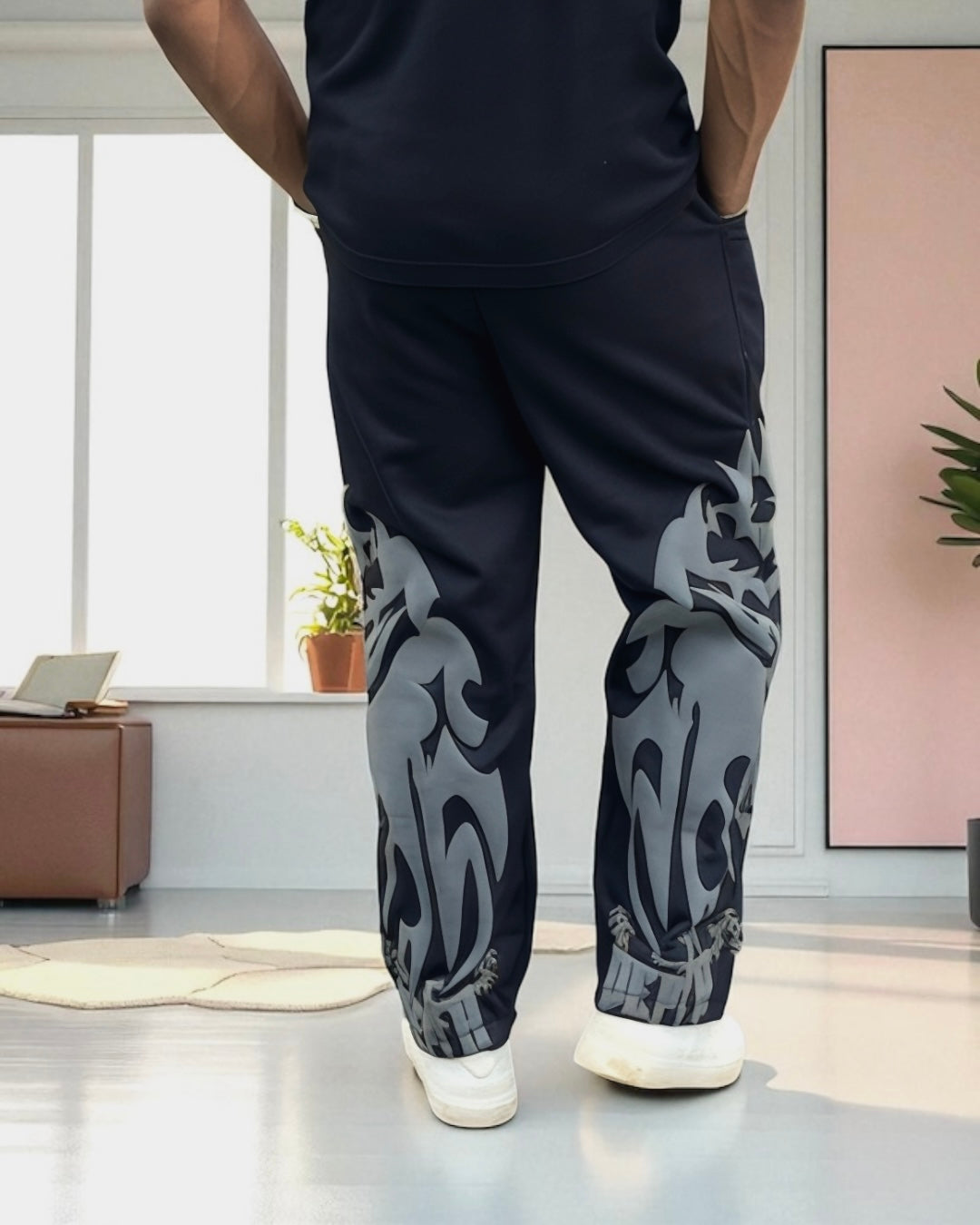 Back view of straight-fit pant in solid black with puff print accents