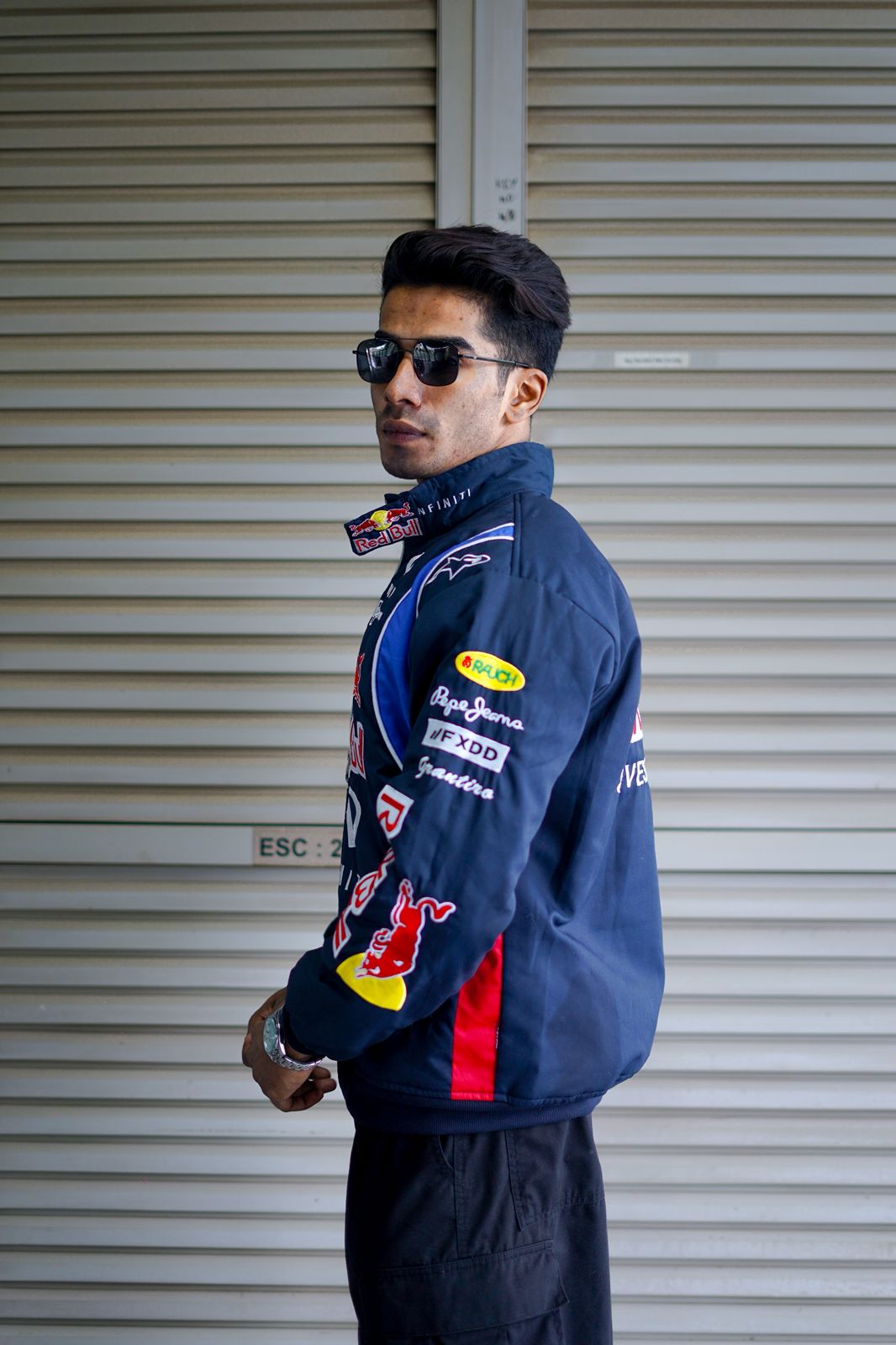 Side profile of Red Bull F1 jacket showing detailed stitching and oversized fit